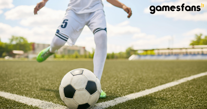 A boy kicking the football.
